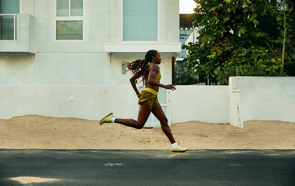 a woman running down a street