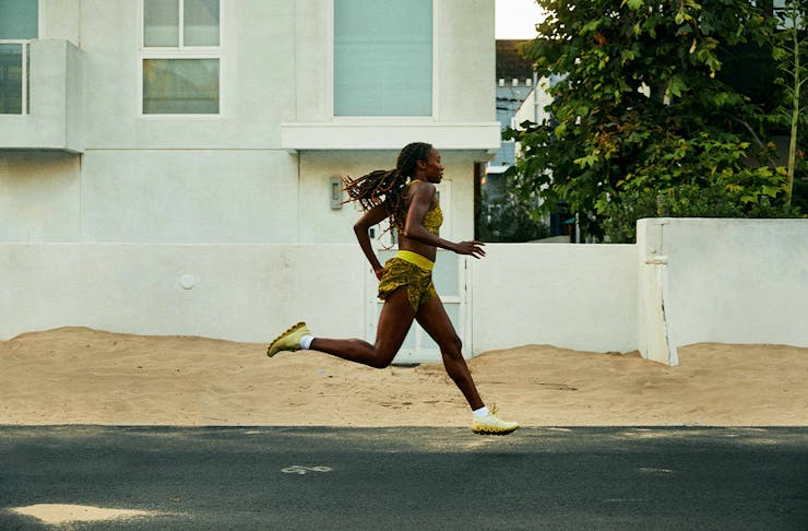 a woman running down a street