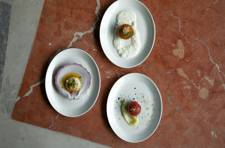 Three plates laid out on a marble surface. 