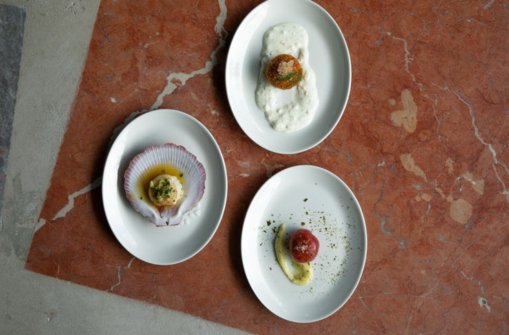 Three plates laid out on a marble surface. 
