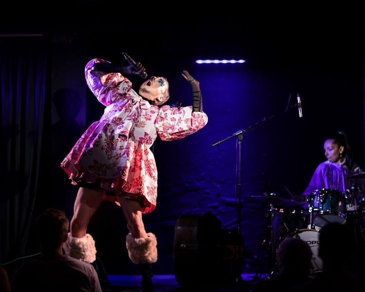 A singer performs in elaborate costume at Sydney Festival.