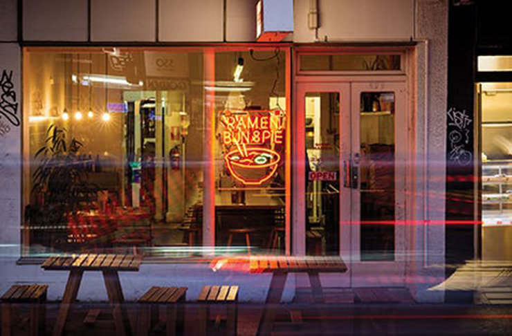 A neon lit window front at Shop Ramen who are dispensing some of the best ramen in Melbourne