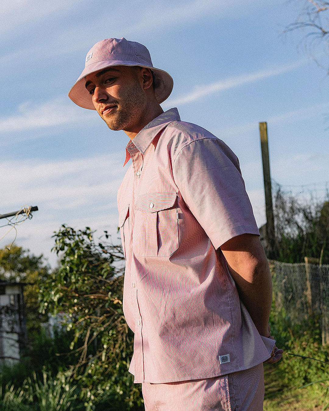 Someone rocks a pink bucket hat with matching pink shirt from Inward Goods, one of the best ethical fashion brands in NZ.