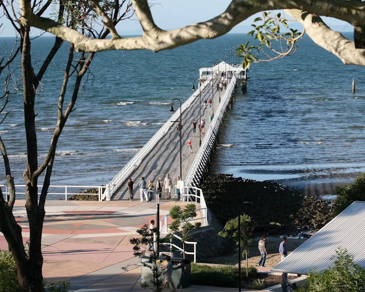 a jetty going out into the ocean, the end of a Brisbane walk in Sandgate