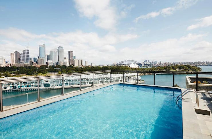 A rooftop pool with a view of Sydney Harbour