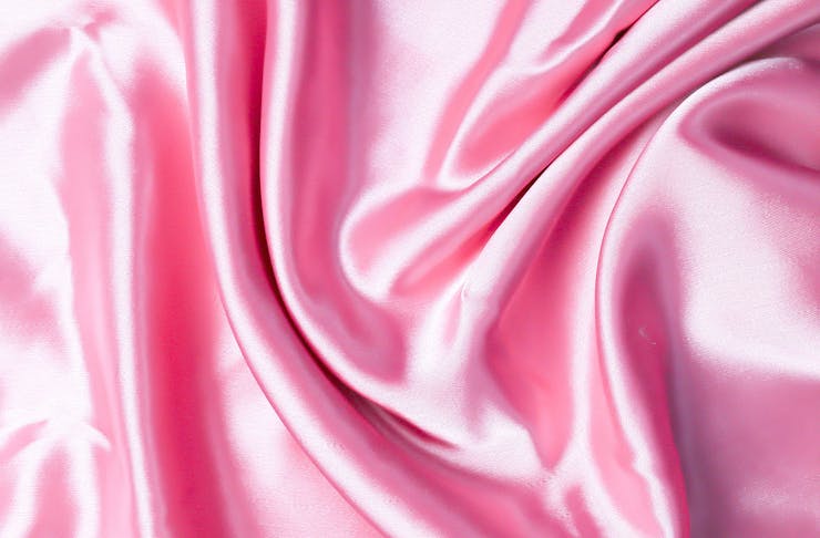 A ruched pink silk pillowcase looks luscious.