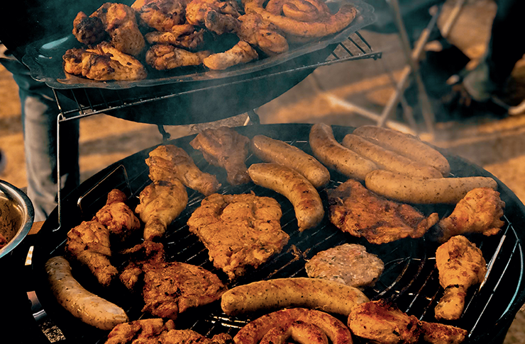 Sausages smoking on a grill.