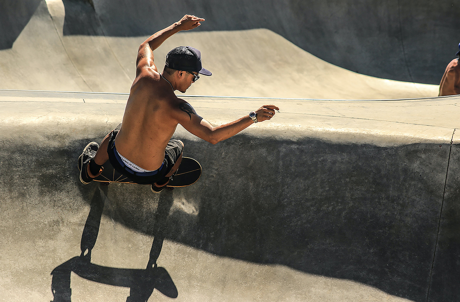 A man skates on a bowl.