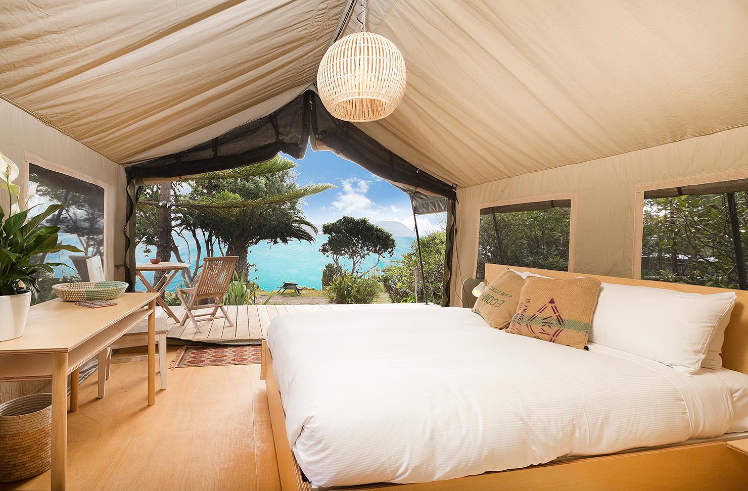 Glamping tent at slipper island looks out over impossibly blue sea.