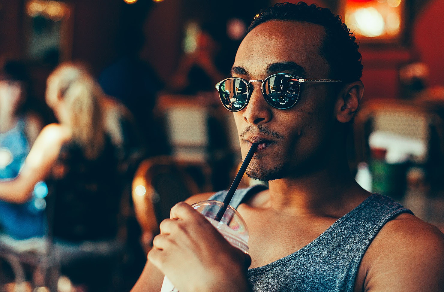A man drinking a smoothie.