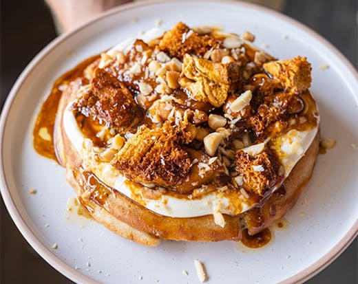 Pancake topped with cream and nuts