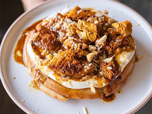 Pancake topped with cream and nuts
