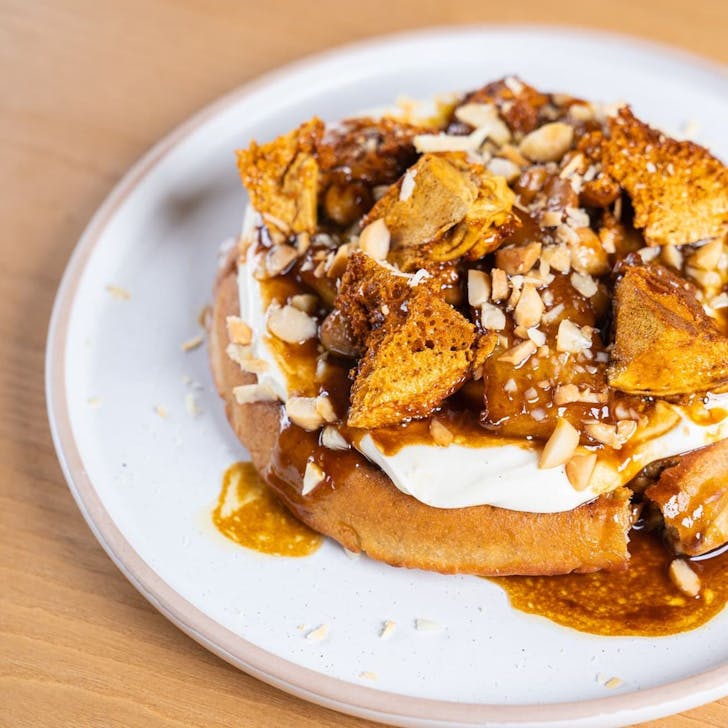 a pancake topped with cream and honeycomb