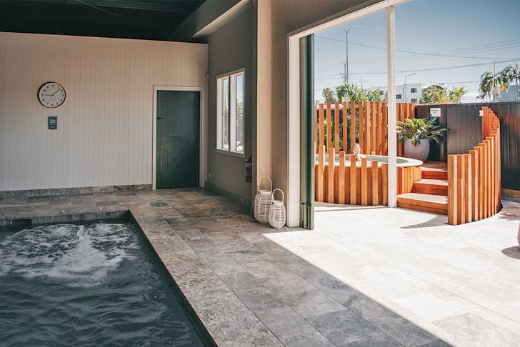 a pool and an outdoor spa at soak bathhouse
