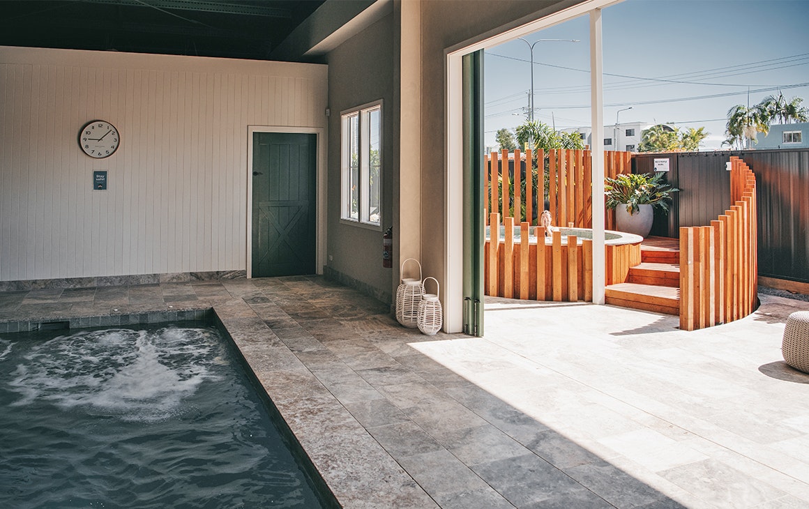 a pool and an outdoor spa at soak bathhouse
