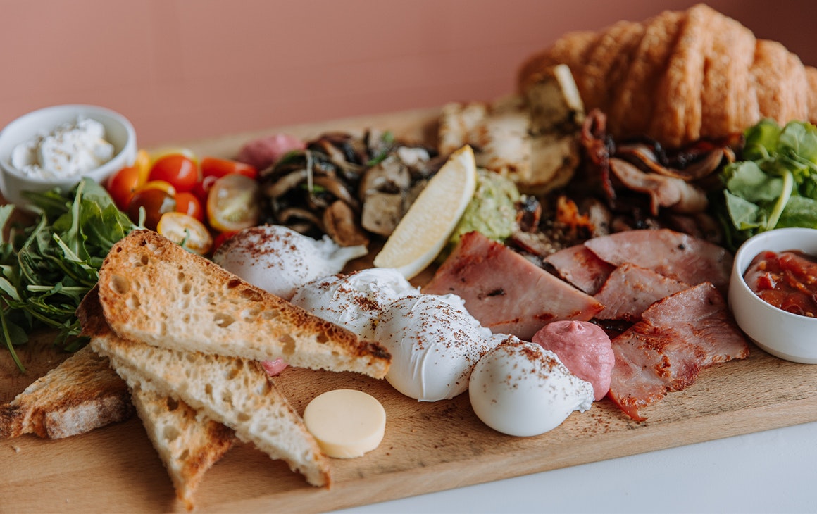 a board piled with breakfast food