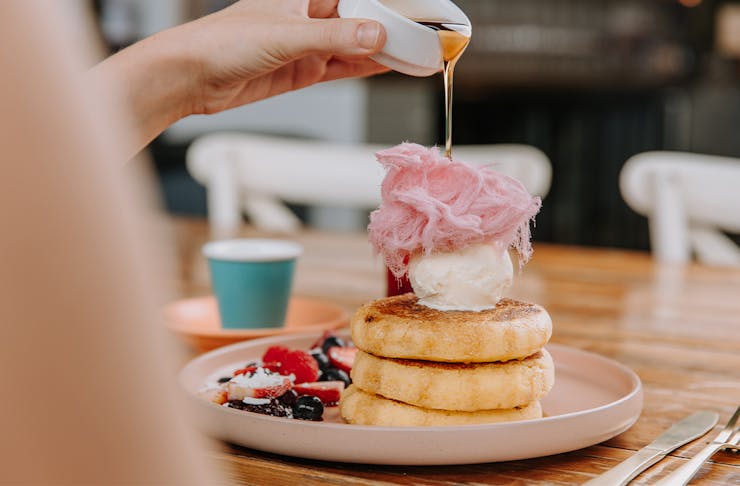 a plate of pancakes topped with fairy floss
