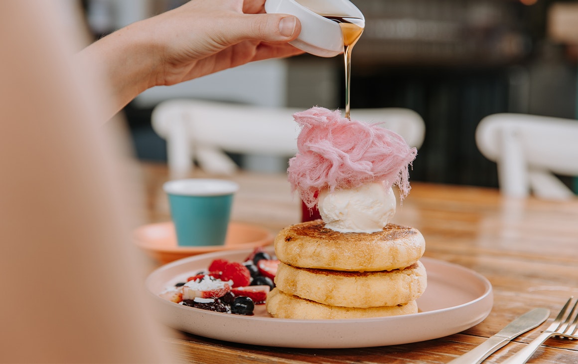 a plate of pancakes topped with fairy floss