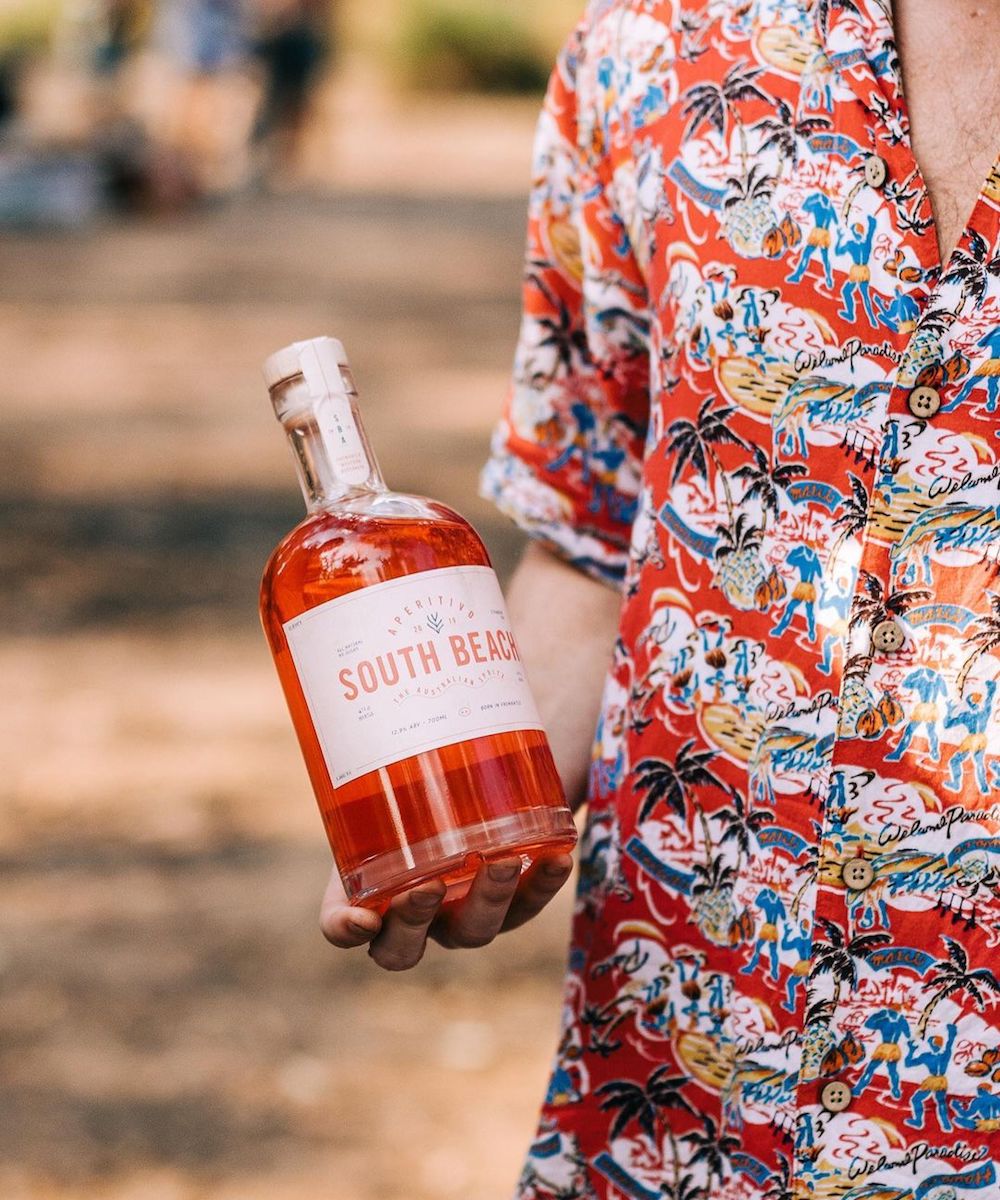 man holds bottle of South Beach Aperitivo