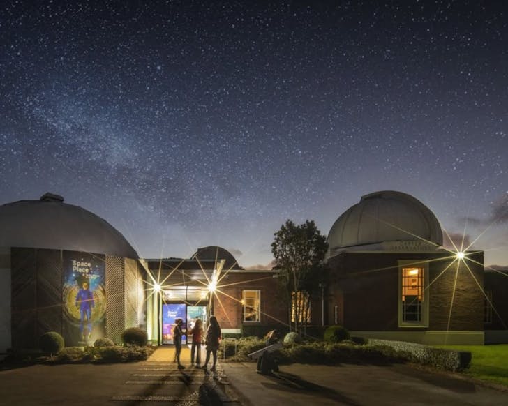 observatory under a night sky full of stars