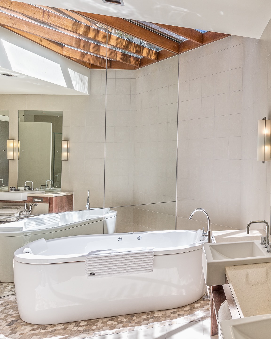 a bath in a bathroom with a skylight at Queensland resort Spicers Peak Lodge