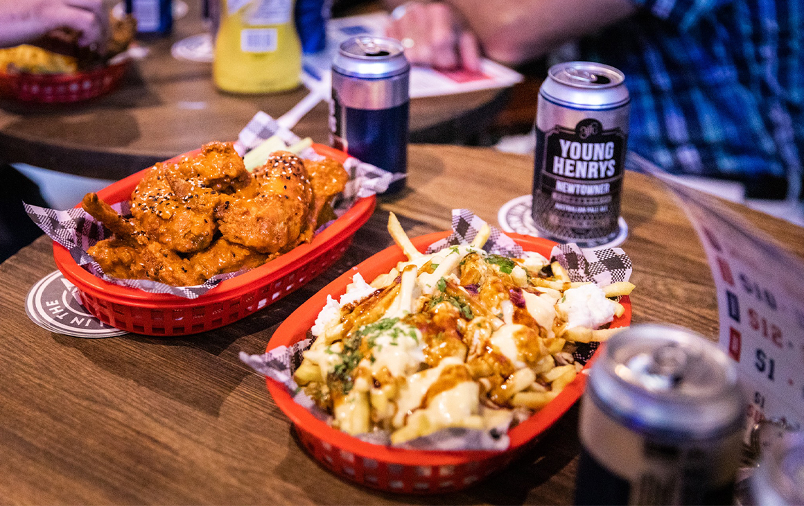 a basket of wings and poutine