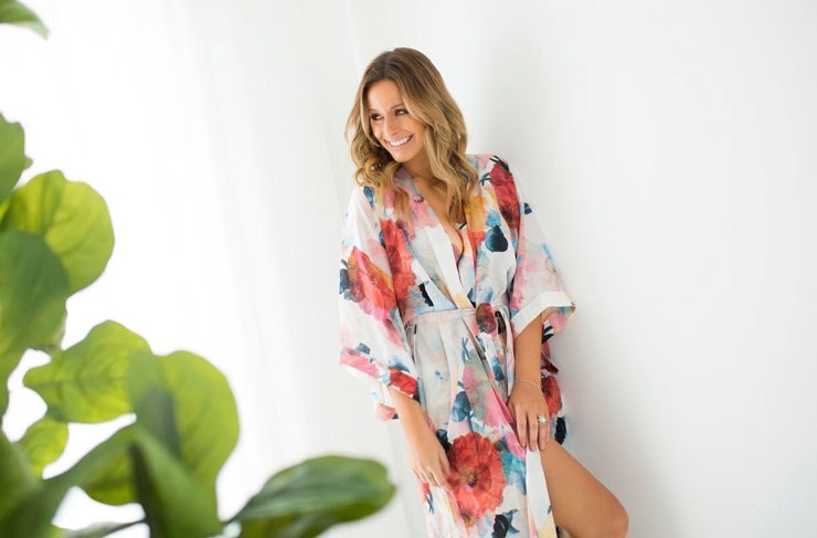 A model wearing a floral printed silk robe. 