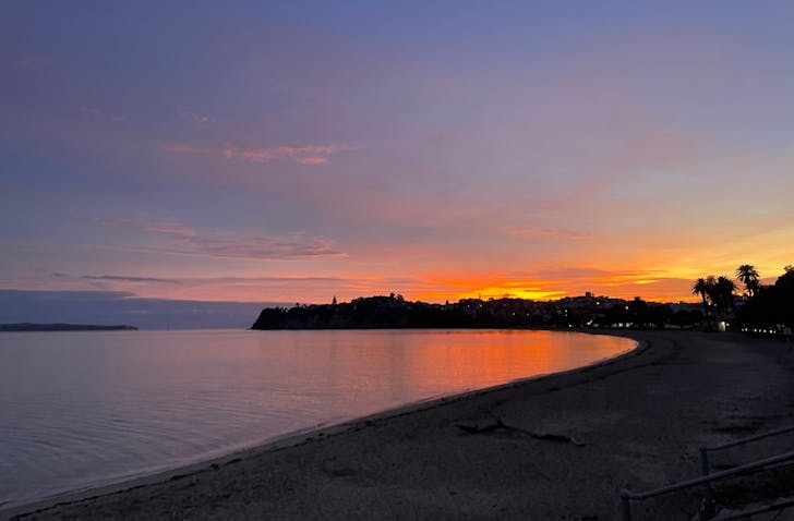 A beautiful purple sky and orange sunset over St Heliers Beach.