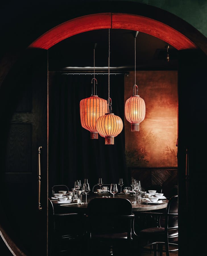 a dimly lit dining room behind a round doorway