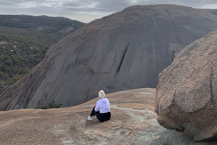 a person sitting on a granite mountain
