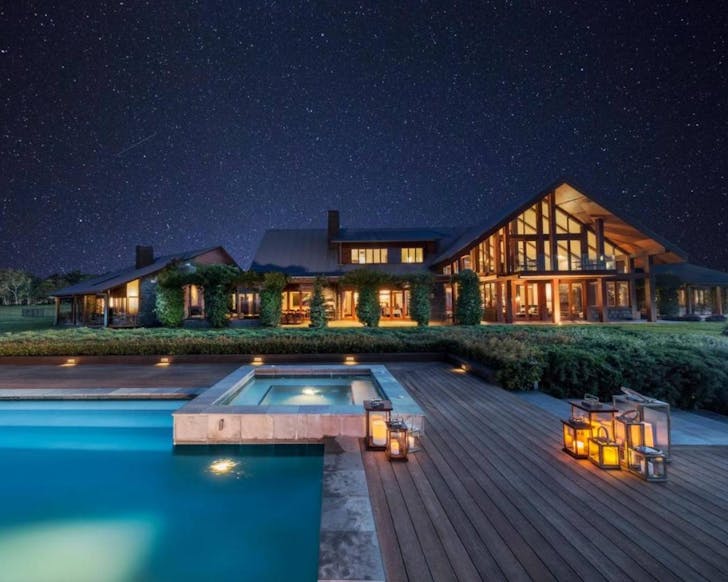 mansion with pool under stars at night