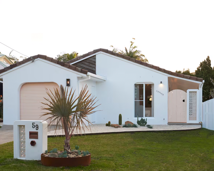 An exterior view of Stay Casita Airbnb with its pink Palm Springs-style accents, a pet-friendly stay near Sydney