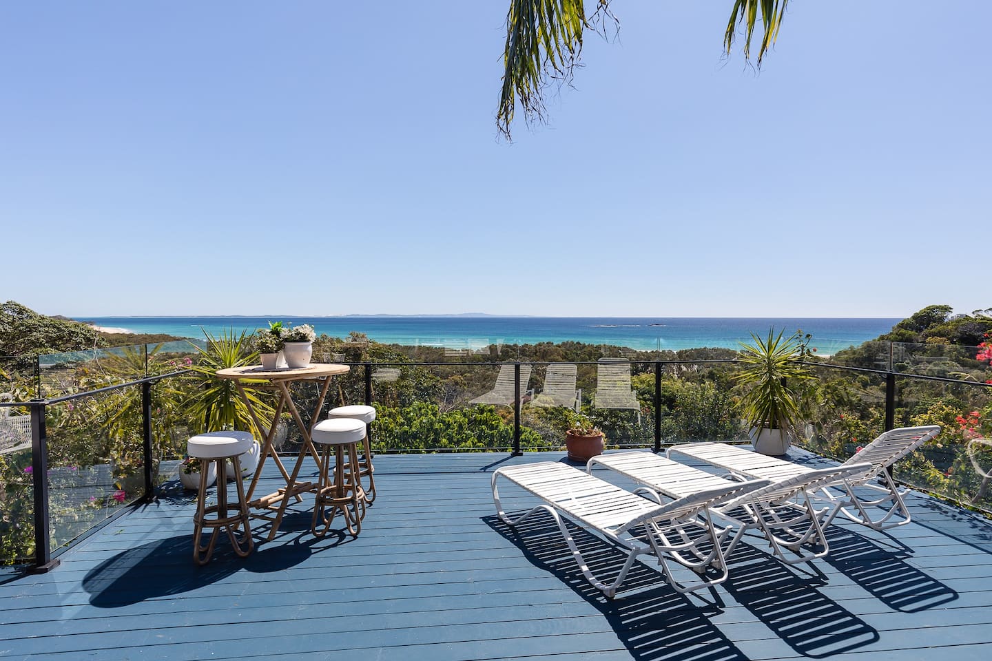 a stradbroke island accomodation with a large deck overlooking the beach