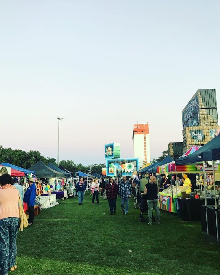 The market stalls at The Strand Night Markets at sunset.