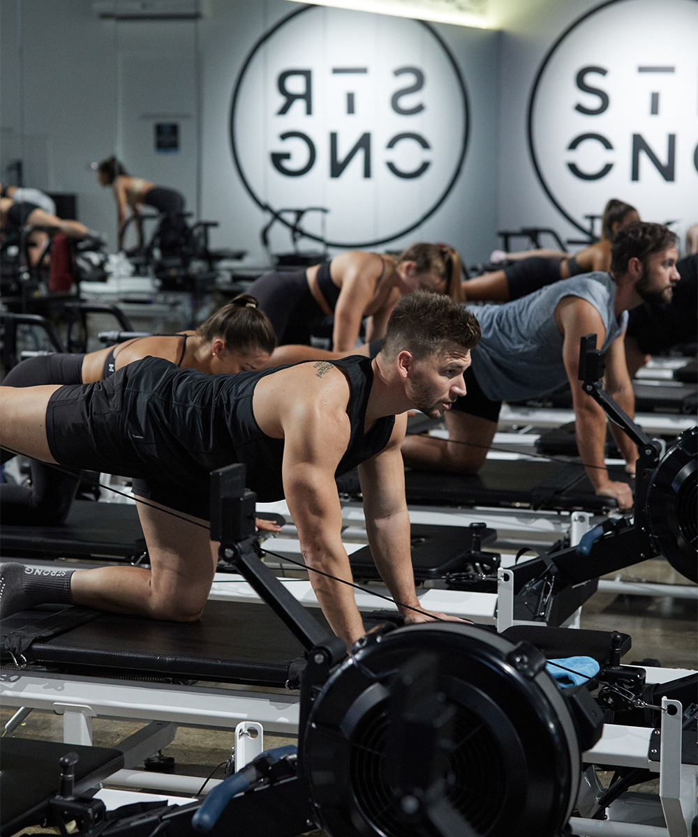 people on a reformer bed doing exercise