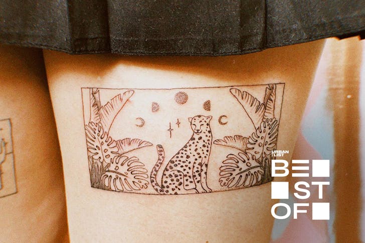 Someone with a cute tattoo on the back of their thigh from Studio Alora.
