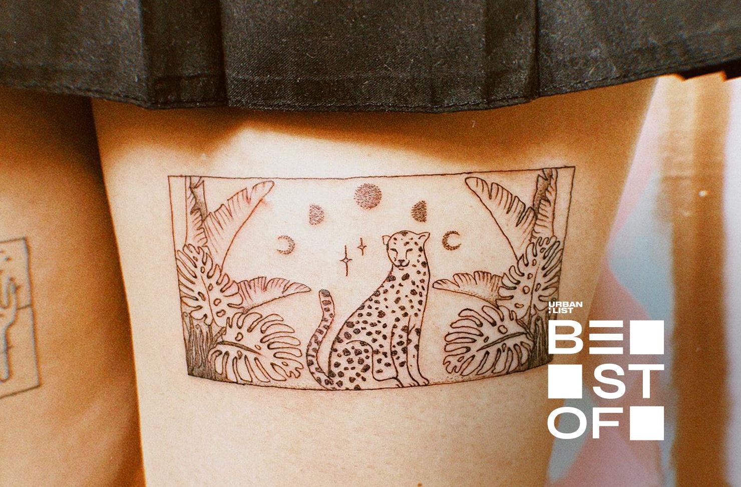 Someone with a cute tattoo on the back of their thigh from Studio Alora.