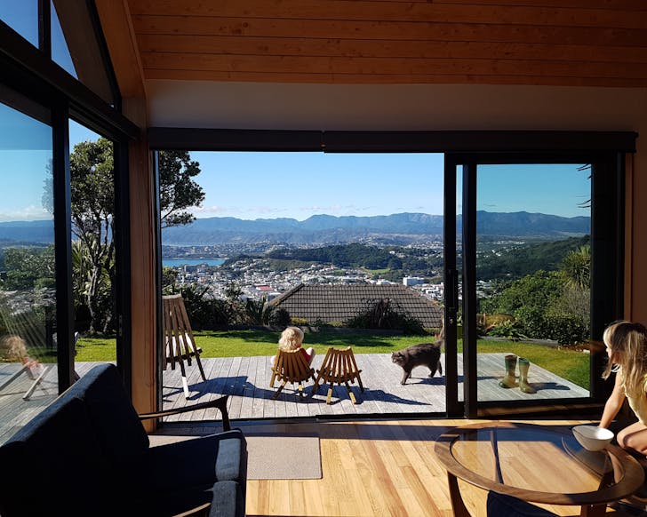 The beautiful lounge space outlooking the deck with the view of Wellington city in the background