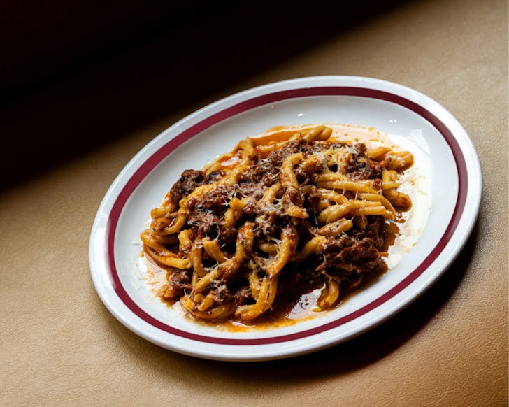 A dimly lit bowl of pasta at studio amaro