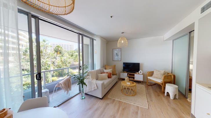 a lounge room in an apartment full of wicker furniture
