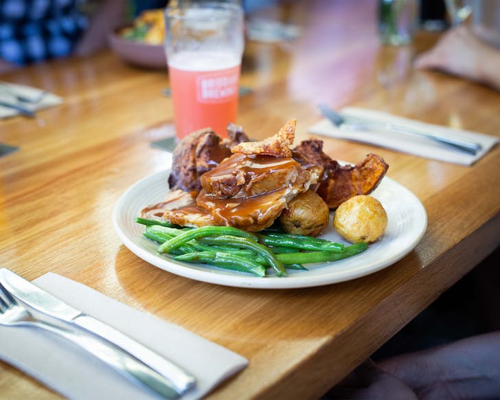 a plate of Sunday roast beef, potatoes and beans at Brisbane Brewing Co