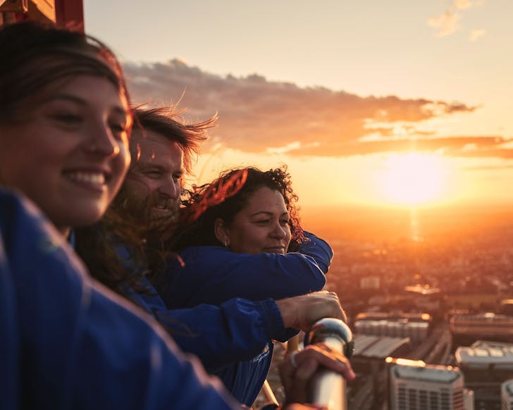 people watching the sunset from the sky tower in the sydney cbd