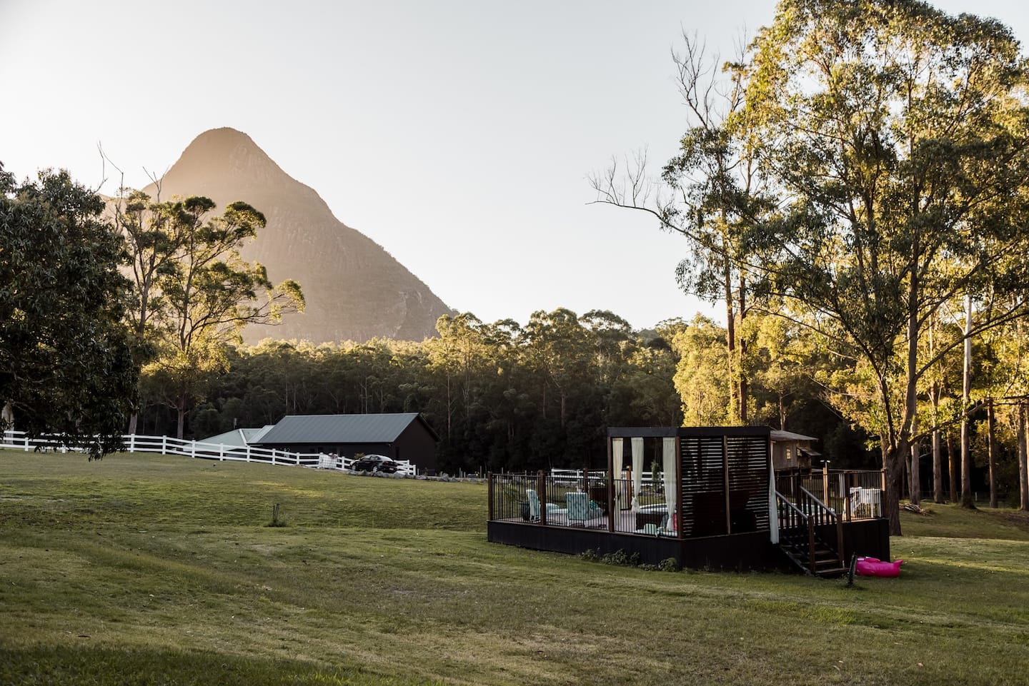 a view of mountains over a pool house