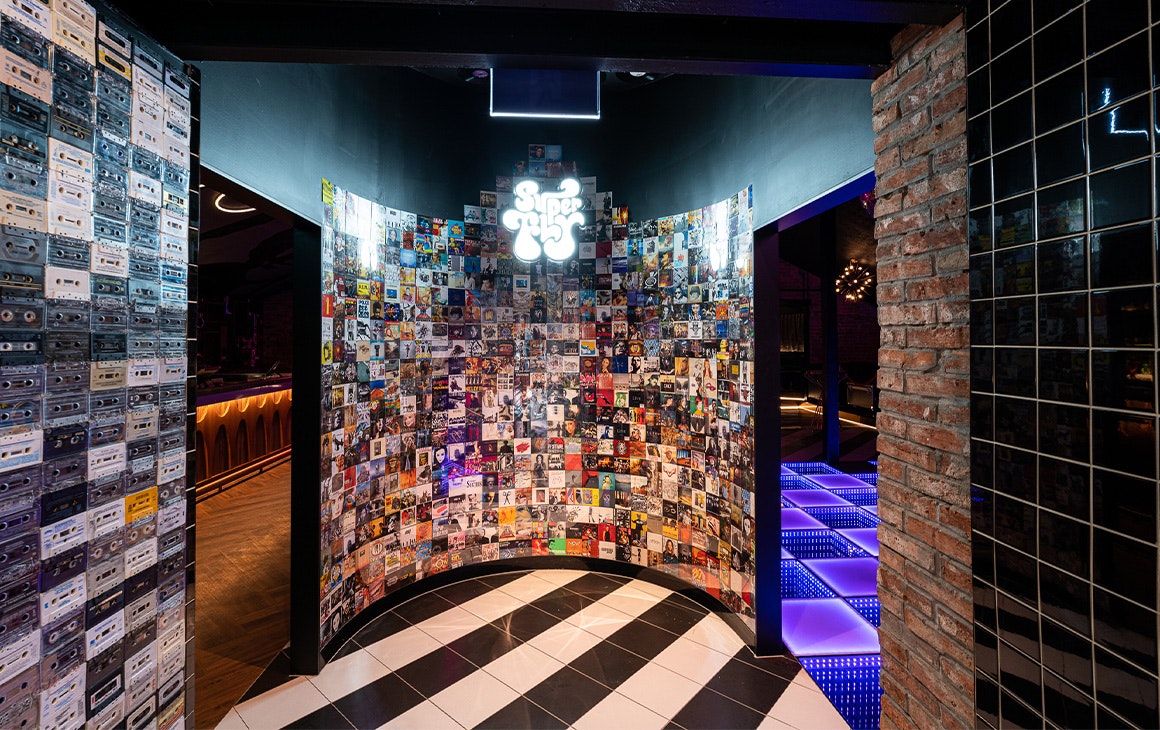 a wall of cd covers and cassette tapes