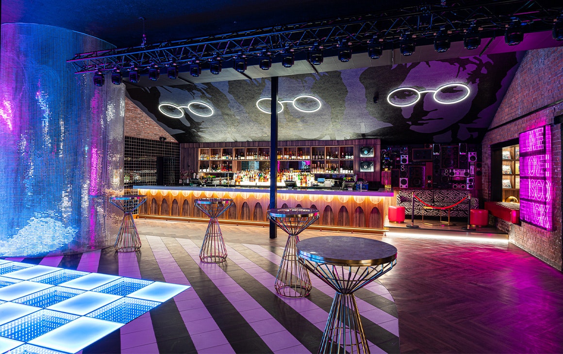 a bar with a mural of a face above it