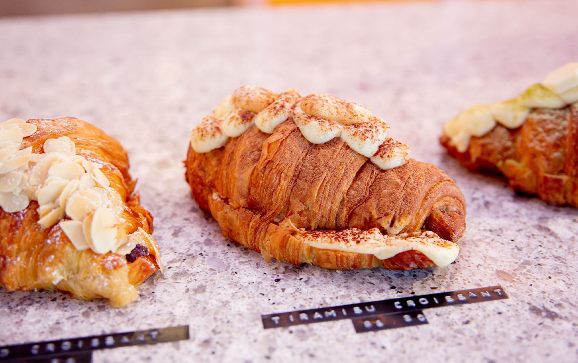 a row of croissants on a bench
