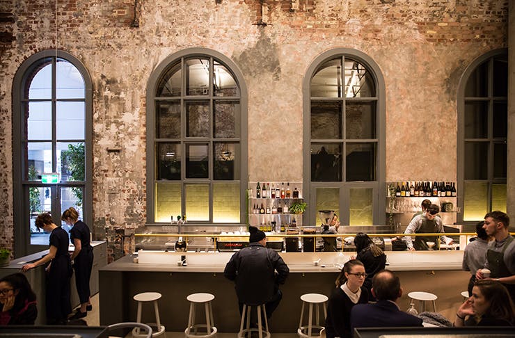 The interior of Higher Ground. Exposed bricks line the walls.