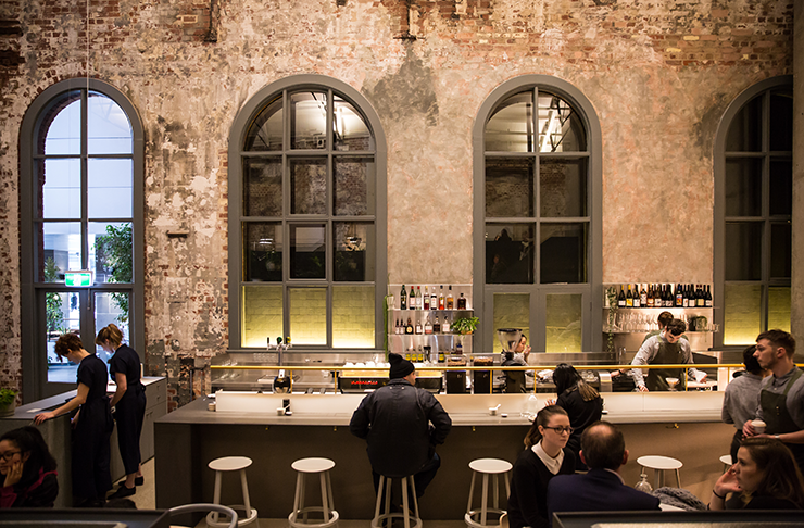 The interior of Higher Ground. Exposed bricks line the walls.
