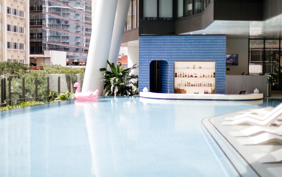 a rooftop pool with a bar