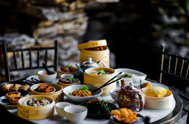 A table stacked with yum cha and Chinese dishes. 